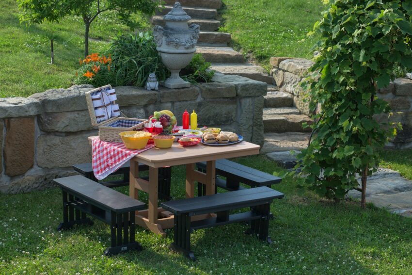 beige and black picnic table with variety of sandwiches prepared during daytime